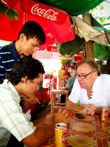 Bill sharing  Ankor beers at a street cafe in Phnom Penh